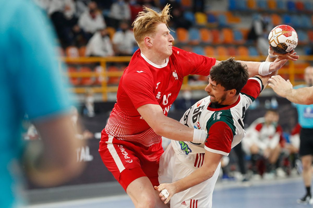 Poland's left back Tomasz Gebala (L) challenges Hungary's centre back Mate Lekai during the 2021 World Men's Handball Championship match between Group I teams Poland and Hungary at the New Capital Sports Hall in the Egyptian capital Cairo on January 23, 2021. (Photo by Petr David Josek / POOL / AFP)