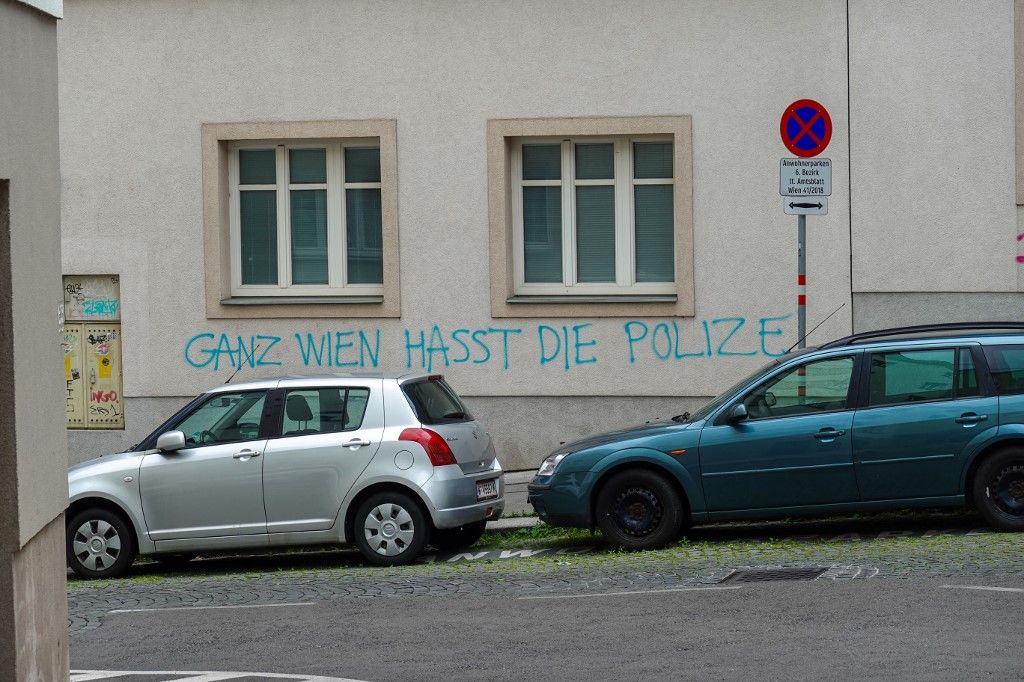 Graffiti reading ''GANZ WIEN HASST DIE POLIZEI'' (''All of Vienna hates the police'') is seen sprayed on the wall of a residential building in Vienna, Austria, on June 7, 2025. The message appears beneath two windows next to parked cars and a residents-only parking sign. (Photo by Michael Nguyen/NurPhoto) (Photo by Michael Nguyen / NurPhoto via AFP)