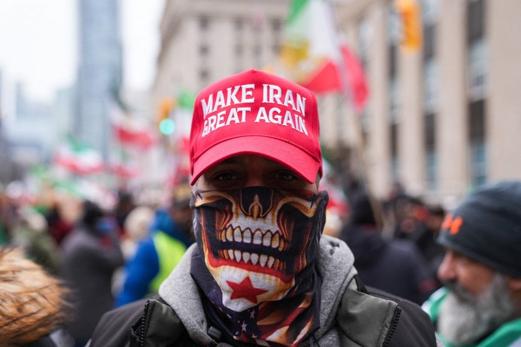 TORONTO, CANADA - JANUARY 13 : A person wearing a cap which reads 'Make Iran Great Again' seen as Iranian people living in Toronto attend a demonstration in solidarity with protesters in Iran, on January 13, 2026 in Toronto, Ontario, Canada. Protestors carrying pre-revolution Iranian flags gathered outside U.S. Consulate General in Toronto to show solidarity with the Iranian people and protest repression in Iran. Mert Alper Dervis / Anadolu (Photo by Mert Alper Dervis / Anadolu via AFP)