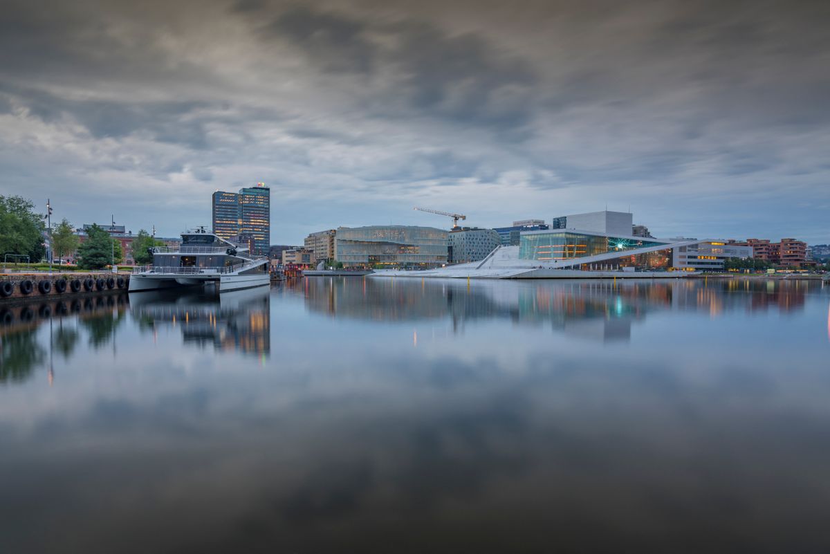 View of Oslo Opera House and Munch Museum reflecting in harbour on cloudy day, Oslo, Norway, Scandinavia, Europe (Photo by Frank Fell / Robert Harding RF / robertharding via AFP)