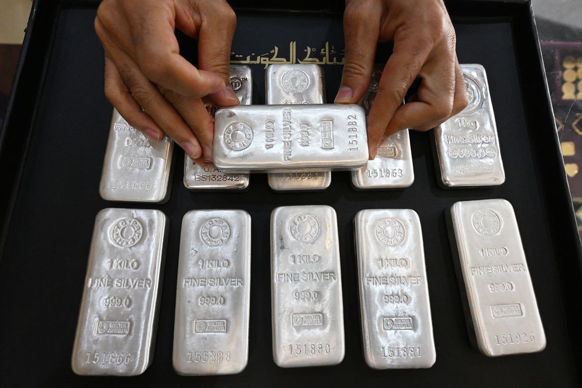 A jeweller arranges silver bars at his shop in downtown Kuwait City on January 12, 2026. Gold vaulted toward $4,600 an ounce and silver approached $85 for the first time. (Photo by YASSER AL-ZAYYAT / AFP)