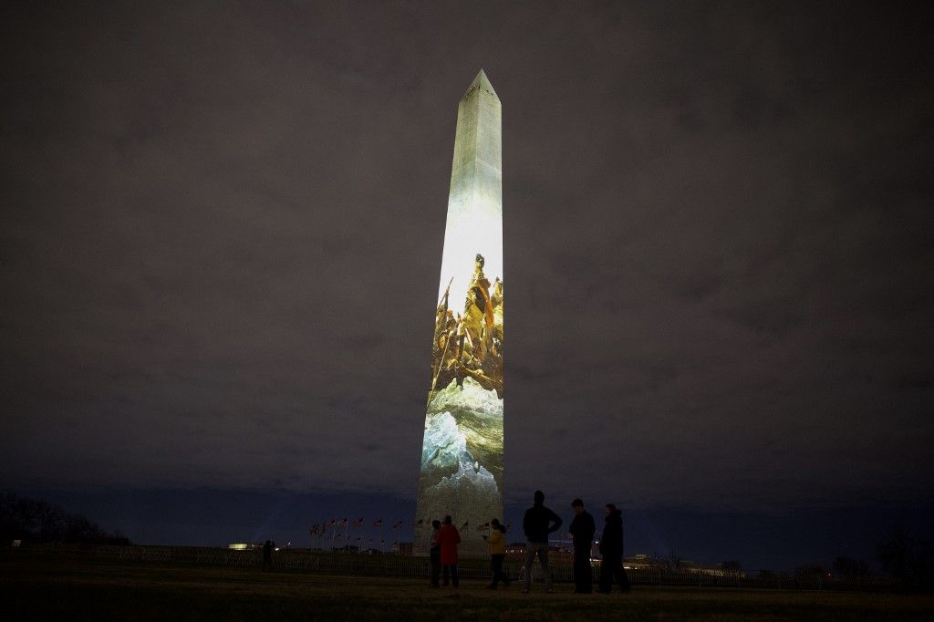 The Washington Monument is illuminated with a projection of US President Donald Trump's "Freedom 250" initiative during the New Year's Eve show at the National Mall in Washington, DC on December 31, 2025. The Washington Monument is illuminated to start the beginning of a momentous year for the US, as it marks 250 years since the Declaration of Independence was signed. (Photo by Amid FARAHI / AFP)