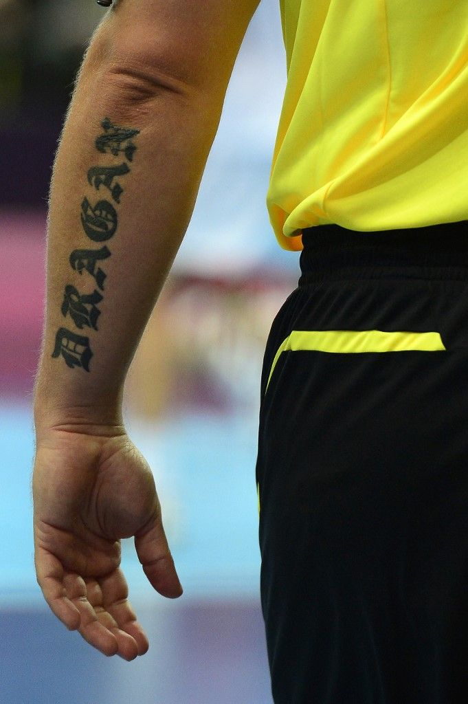 A tattoo on the left arm of Macedonian referee Dragan Nachevski is seen during the men's preliminaries Group B handball match South Korea vs Hungary for the London 2012 Olympics Games on July 31, 2012 at the Copper Box hall in London. AFP PHOTO/ JAVIER SORIANO (Photo by JAVIER SORIANO / AFP)
