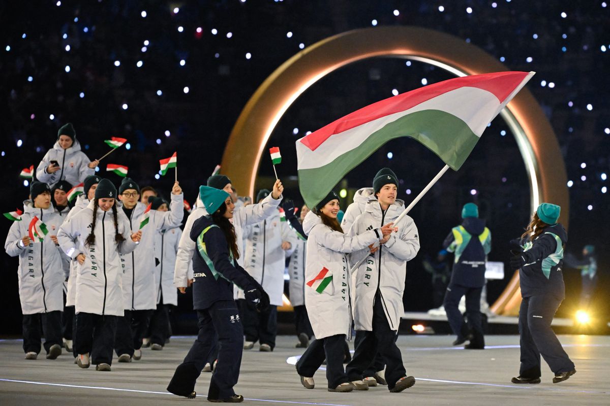 Hungary's flag bearer Maja Dora Somodi and Hungary's flag bearer Bence Mark Nogradi parade during the opening ceremony of the Milano Cortina 2026 Winter Olympic Games at the San Siro stadium in Milan, northern Italy, on February 6, 2026. (Photo by WANG Zhao / AFP)