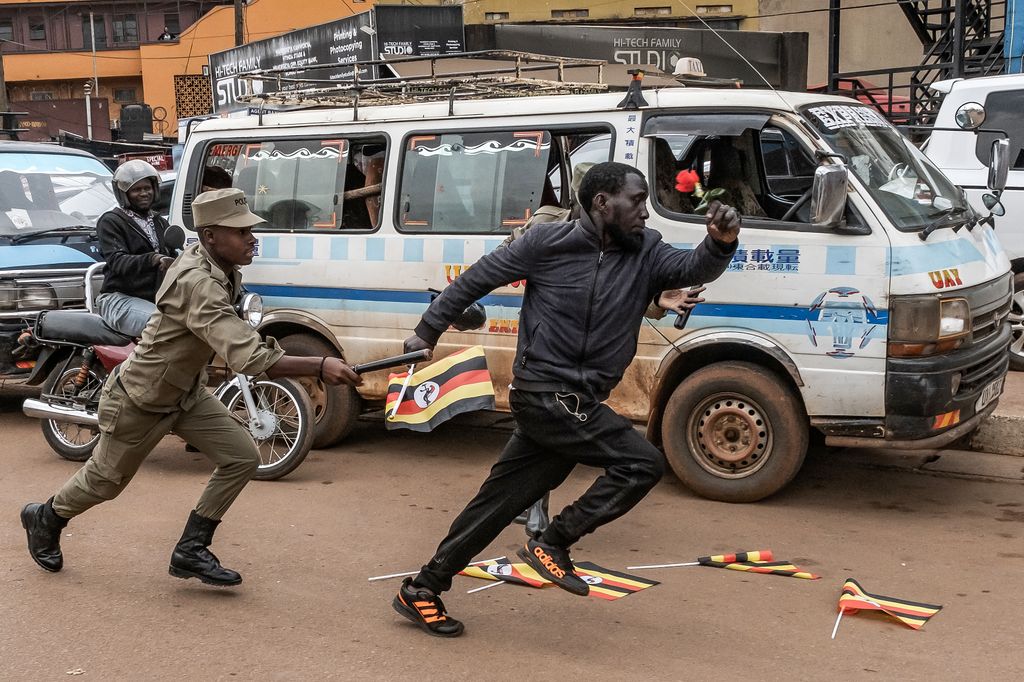 Uganda - Rendőrök próbálnak letartóztatni egy férfit egy ellenzéki tüntetés után Kampalában
