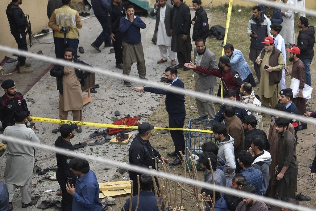 Security personnel and locals gather at a blast site inside a mosque in Islamabad on February 6, 2026. A blast at a Shiite mosque in Pakistan's capital Islamabad on February 6 killed 15 people and wounded at least 80, local authorities said. (Photo by Ghulam RASOOL / AFP)