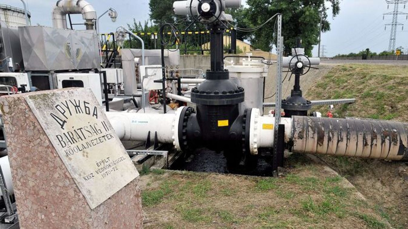 The Druzhba II oil pipeline entering the Mol Danube Refinery with its main shut-off valve, and a commemorative plaque in the foreground, Szazhalombatta, July 25, 2013. The Danube Refinery is the Mol Group's largest and Hungary's only crude oil processing