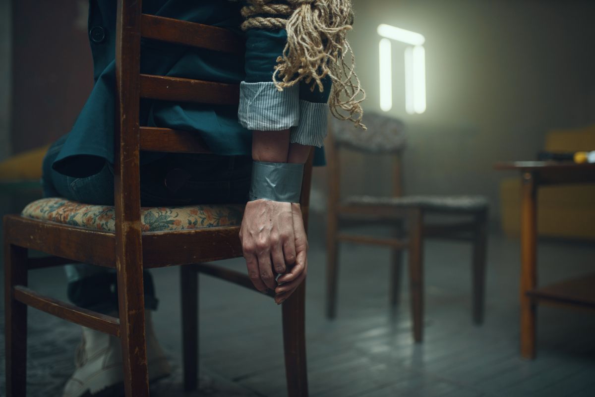 Female victim of maniac kidnapper with taped hands