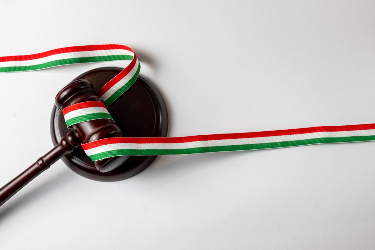 Hungarian justice concept with gavel and tricolor ribbon on white background