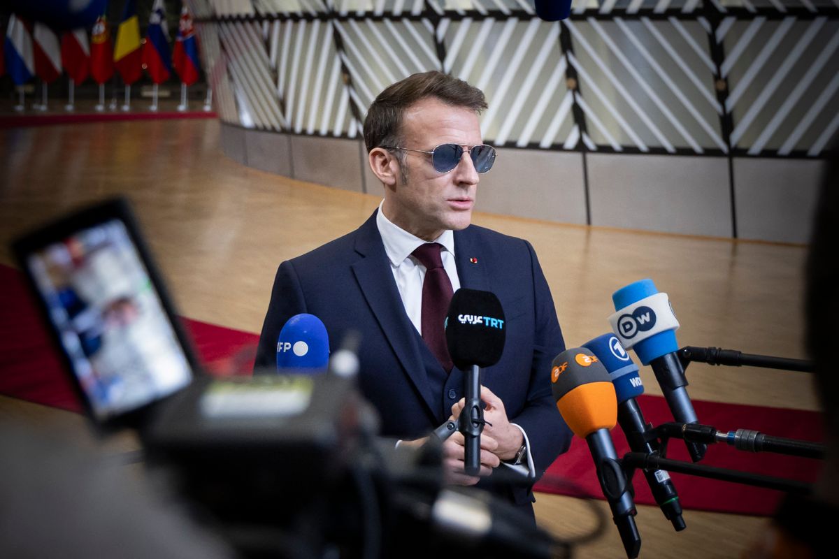 President of France Emmanuel Macron talks to the press and international media at a doorstep briefing ahead of the emergency Special meeting of the EUCO. The Informal meeting of the Members of the European Council in the Europa building, the EU Council headquarters amid geopolitical tension initiated by the US President Donald Trump over the acquisition of Greenland and tariff threats. French President Emmanuel Macron notably wears Henry Jullien Pacific S 01 aviator sunglasses, a French luxury brand that gained global attention after he wore them at the World Economic Forum in Davos. Brussels, Belgium on January 22, 2026  (Photo by Nicolas Economou/NurPhoto) (Photo by Nicolas Economou / NurPhoto via AFP)
