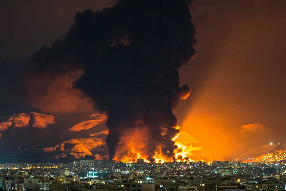 Smoke and flames rise at the site of airstrikes on an oil depot in Tehran on March 7, 2026. The United States and Israel launched strikes against Iran on February 28, prompting Iranian retaliation with missile attacks across the region and intensifying concerns about disruption to global energy and transport. (Photo by Sasan / Middle East Images via AFP)