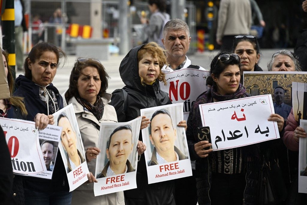 Demonstrators hold posters with a portrait of Swedish-Iranian doctor and researcher Ahmadreza Djalali (Ahmad Reza Jalali) who is imprisoned and sentenced to death in Iran, during a protest claiming to free him, on May 14, 2022 in Stockholm, Sweden. Ahmadreza Djalali is at risk of an execution that media reports say is due to be carried out by May 21, over his 2017 conviction on spying charges that are vehemently denied by his family. (Photo by Anders WIKLUND / TT News Agency / AFP) / Sweden OUT