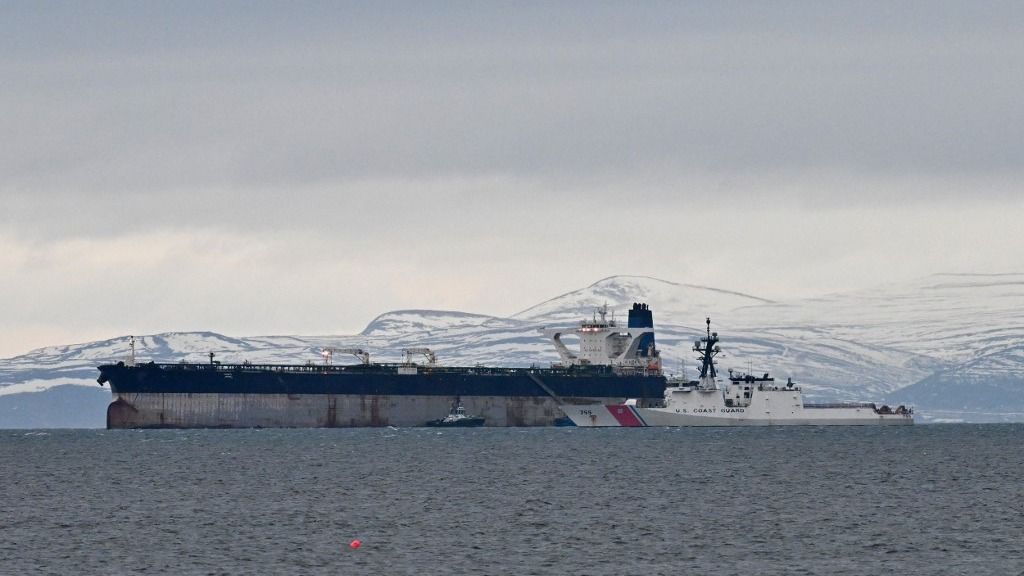 An oil tanker formerly known as the Bella-1, before it changed its name to the Marinera, is pictured alongside a US coast guard ship, at sea in the Moray Firth, northern Scotland, on January 14, 2026. Britain said on January 7, it provided "enabling support" during a US operation to seize the Russian-flagged oil tanker in the North Atlantic, which was condemned by Moscow. The seized tanker had been sanctioned by Washington under measures targeting Iran, and had been "initially flying a false flag", according to the Ministry of Defence. (Photo by ANDY BUCHANAN / AFP)