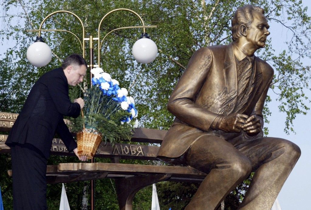 Igor Surkis, President of Kiev's FC Dynamo puts flowers on a Valeriy Lobanovsky monument during a ceremony in front of Kiev stadium 11 May 2003. The monument opening was devoted to the first anniversary of the death of 63 year-old Lobanovsky, first as a player of Dynamo and then outstanding main coach of the club. Well-known in the world, Valeriy Lobanovsky was favoured by millions of Ukrainians. 
AFP PHOTO/ SERGEI SUPINSKY (Photo by SERGEY SUPINSKI / AFP)