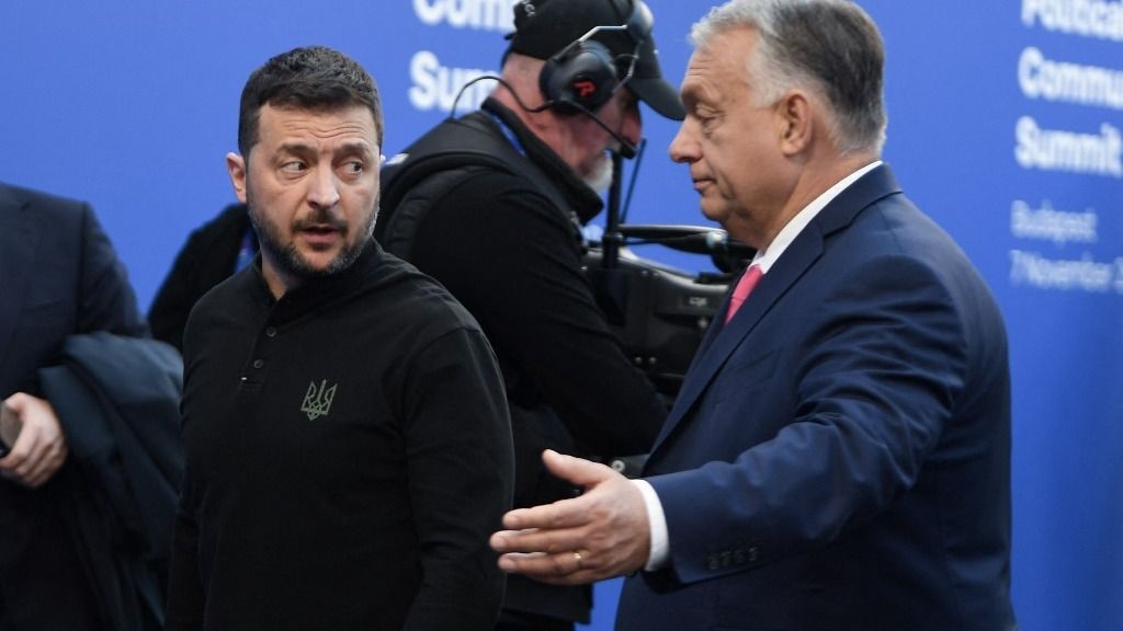 Ukraine's President Volodymyr Zelensky (L) is greeted by Hungary's Prime Minister Viktor Orban as he arrives to attend the European Political Community Summit in Budapest, on November 7, 2024. (Photo by Ferenc ISZA / AFP)