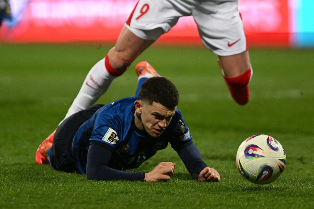Kosovo's defender #19 Dion Gallapeni reacts after suffering a foul during the FIFA World Cup 2026 European qualification final football match between Kosovo and Turkey at the Fadil Vokrri stadium in Pristina on March 31, 2026. (Photo by Armend NIMANI / AFP)