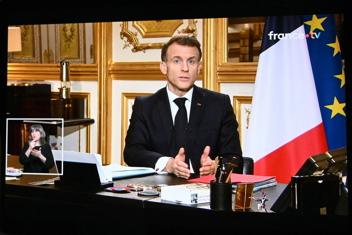 This photograph shows screens broadcasting French President Emmanuel Macron's address on the war in Iran and its repercussions in the Middle East, from the Elysee Palace in Paris on March 3, 2026. (Photo by SEBASTIEN BOZON / AFP)