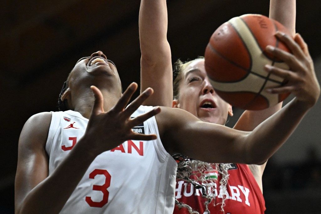 Japan's Stephanie Mawuli (L) vies with against Hungary's Bernadett Hatar during the 2024 FIBA Women's Olympic qualifying tournament basketball match between Hungary and Japan in Sopron, Hungary on February 9, 2024. (Photo by ATTILA KISBENEDEK / AFP)