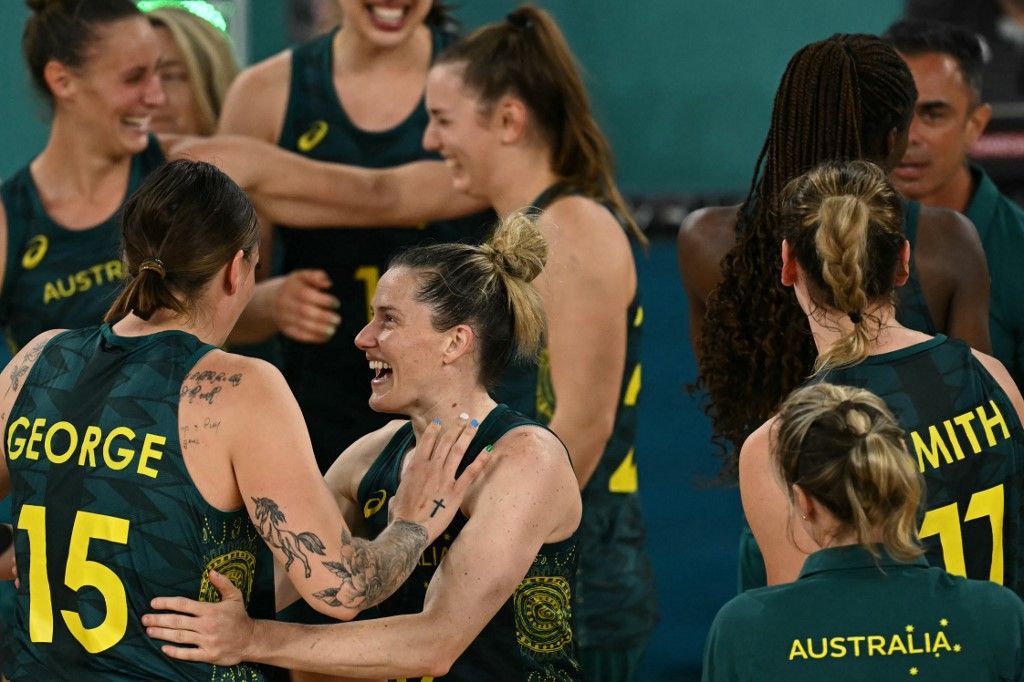 Australia's #15 Cayla George and Australia's #32 Sami Whitcomb (C) celebrate in the women's Bronze Medal basketball match between Belgium and Australia during the Paris 2024 Olympic Games at the Bercy  Arena in Paris on August 11, 2024. (Photo by Paul ELLIS / AFP)