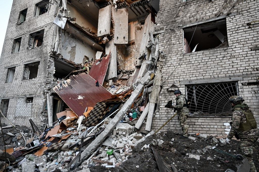 National Police officers work outside a hostel destroyed by an overnight Russian missile and drone attack in Zaporizhzhia, Ukraine, on October 30, 2025. Russian troops launch eight missiles and 20 drones at the southeastern Ukrainian city, killing two people and injuring 23 people. At least 12 apartment blocks are damaged, and a hostel is destroyed, where several floors collapse. (Photo by Dmytro Smolienko/Ukrinform/NurPhoto) NO USE RUSSIA. NO USE BELARUS. (Photo by Ukrinform/NurPhoto) (Photo by Dmytro Smolienko / NurPhoto via AFP)