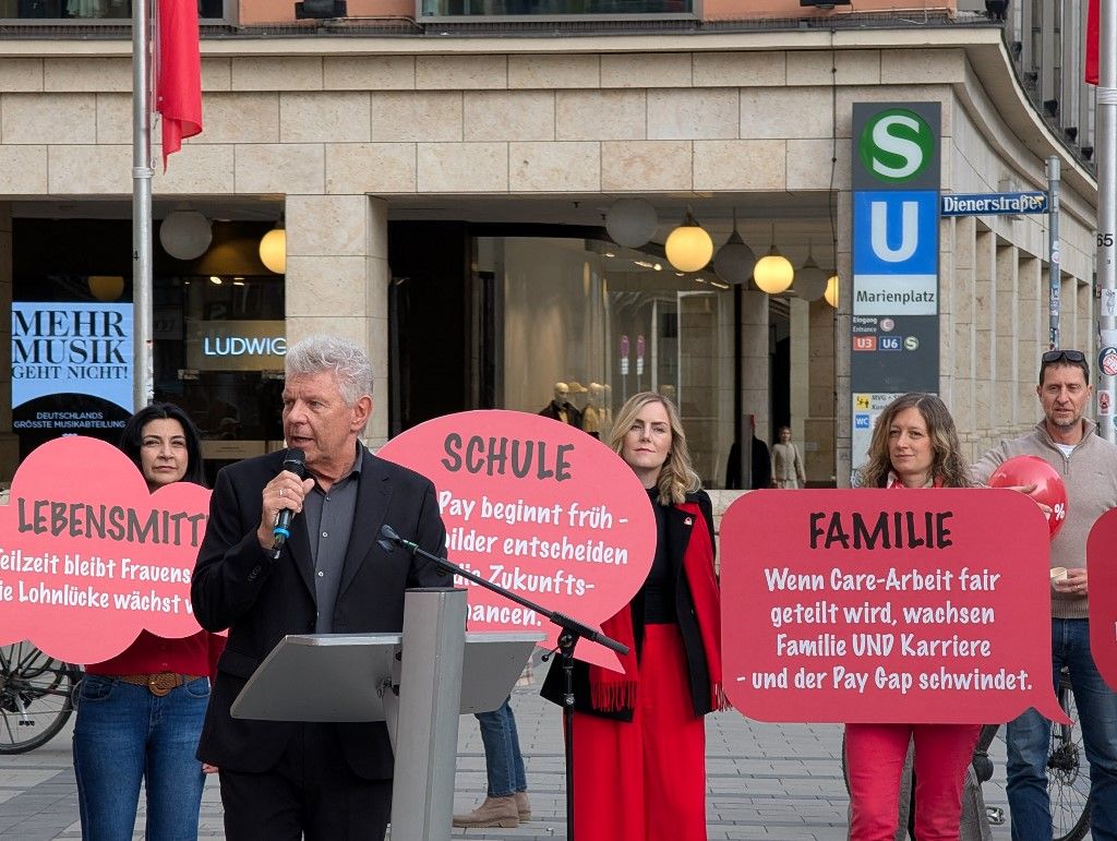 The opening ceremony of Equal Pay Day with the Mayor of Munich, Dieter Reiter, and participants holding red 16 percent balloons takes place in Munich, Bavaria, Germany, on February 26, 2026. Equal Pay Day symbolically marks the gender pay gap, as women in Germany earn 16 percent less than men in 2024 according to official statistics. (Photo by Michael Nguyen/NurPhoto) (Photo by Michael Nguyen / NurPhoto via AFP)