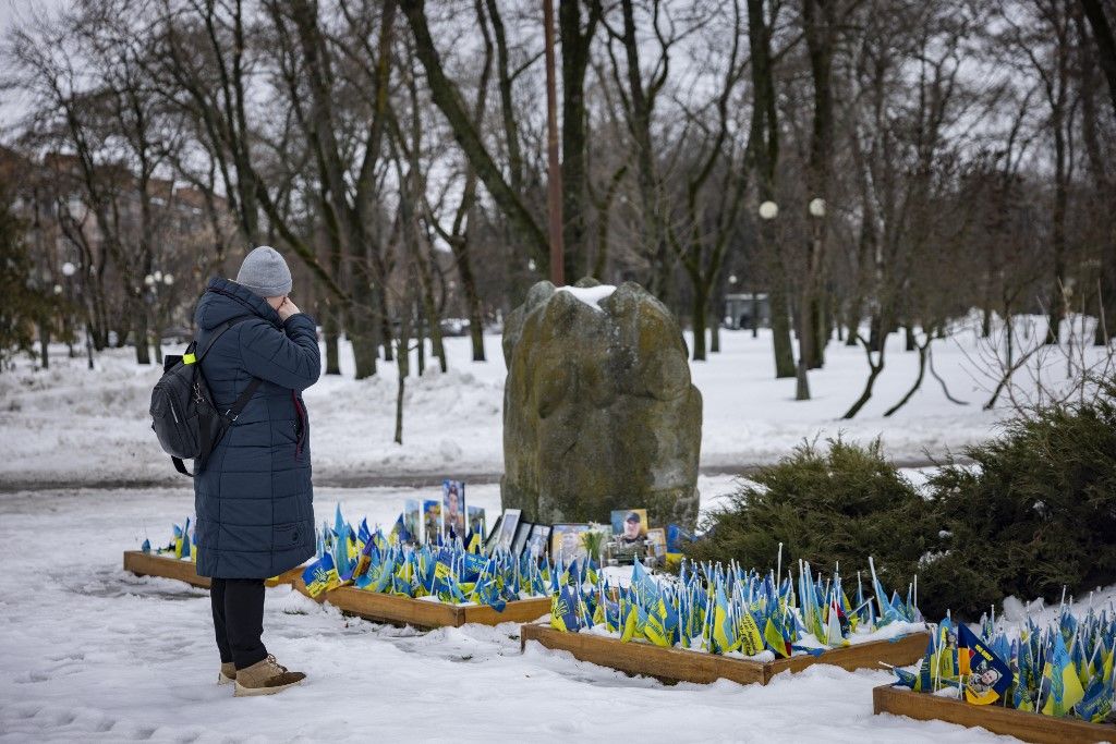 CHERNIHIV, UKRAINE - FEBRUARY 24: Civilians and relatives / loved ones of fallen Ukrainian soldiers attend a commemoration event marking the fourth anniversary of Russia’s full-scale invasion of Ukraine at a memorial cemetery in Chernihiv, Ukraine on February 24, 2026. Maksym Kishka / Anadolu (Photo by Maksym Kishka / Anadolu via AFP)