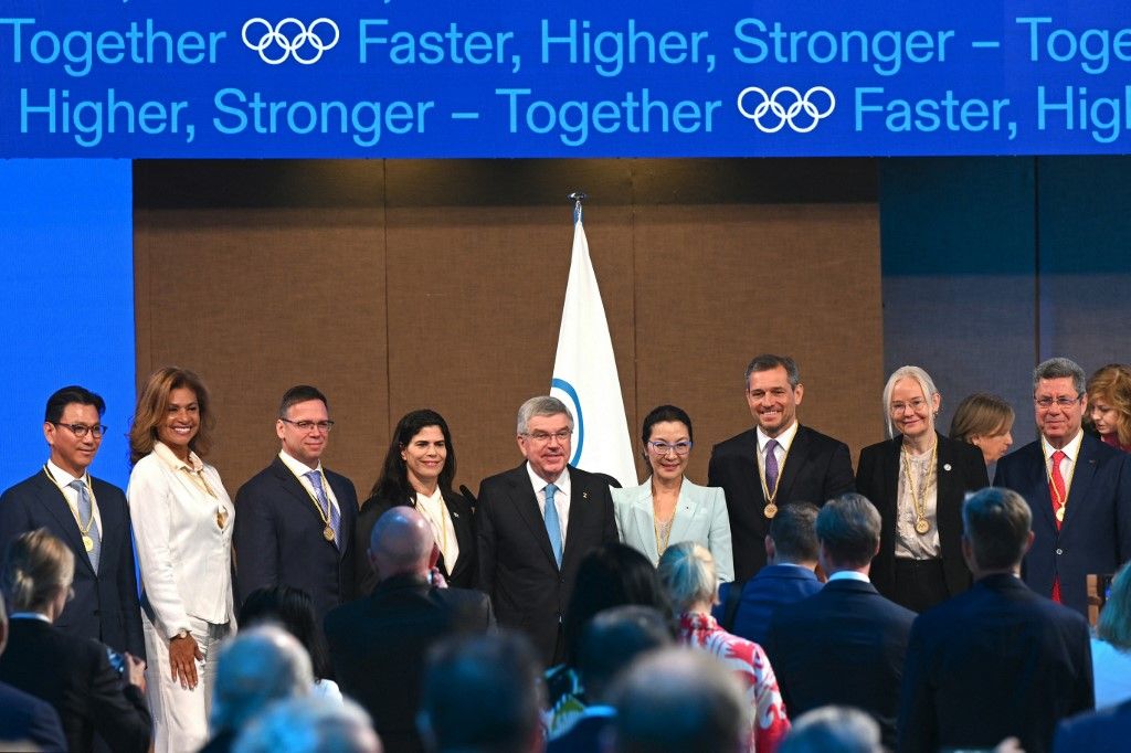 Newly elected International Olympic Committee (IOC) members (from L) South Korea's Kim Jae-youl, president of the International Skating Union, Cecilia Tait, former Olympic medallist and politician from Peru, Hungarian businessman and sports administrator Balazs Furjes, Israel's first Olympic medallist Yael Arad, IOC President Thomas Bach, Malaysian actress Michelle Yeoh, German sports entrepreneur Michael Mronz, Sweden's Petra Soerling, head of the International Table Tennis Federation, and Mehrez Boussayene, president of the Tunisian Olympic Committee, pose for a group picture during the third day of the 141st IOC session in Mumbai on October 17, 2023. (Photo by INDRANIL MUKHERJEE / AFP)