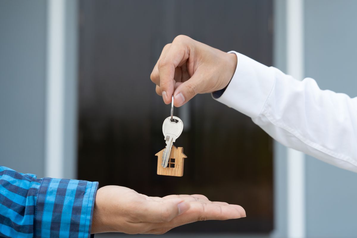 lease, rental and selling home. Real estate agent manager smile holding key for new owner. rent house, Sales, loan credit financial, insurance, Seller, dealer, installment,  buy, sell, move in