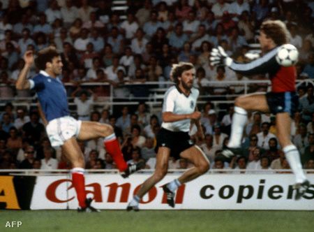 West German goalkeeper Harald Schumacher (R) jumps past the ball as he gets ready to collide with French defender Patrick Battiston during the World Cup semifinal soccer match between West Germany and France. Battiston was carried off the field on a stretcher while Schumacher resumed play. AFP PHOTO