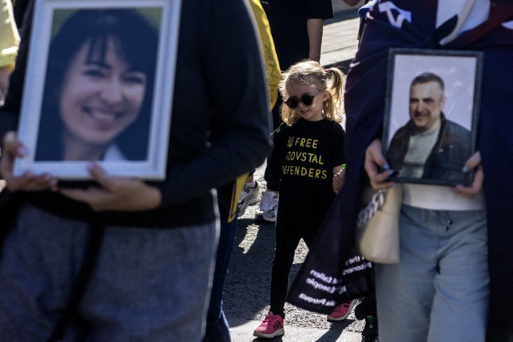 Ukrainians hold portraits of a fallen Ukrainian soldier during a march marking the upcoming Defenders of Ukraine Day in Kyiv, Ukraine, on September 28, 2024 (Photo by Maxym Marusenko/NurPhoto) (Photo by Maxym Marusenko / NurPhoto via AFP)