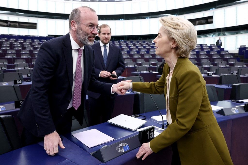 European Commission President Ursula von der Leyen (R) speaks with EPP President Manfred Weber (L) prior to a debate on the conclusions of the European Council meeting of December 19, 2024, as part of a plenary session at the European Parliament in Strasbourg, eastern France, on January 22, 2025. (Photo by FREDERICK FLORIN / AFP)