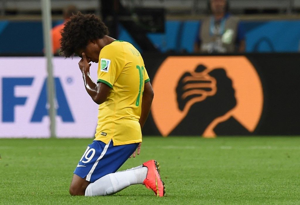 Brazil's midfielder Willian reacts at the end of the semi-final football match between Brazil and Germany at The Mineirao Stadium in Belo Horizonte during the 2014 FIFA World Cup on July 8, 2014. Germany won 7-1. AFP PHOTO / VANDERLEI ALMEIDA (Photo by VANDERLEI ALMEIDA / AFP)