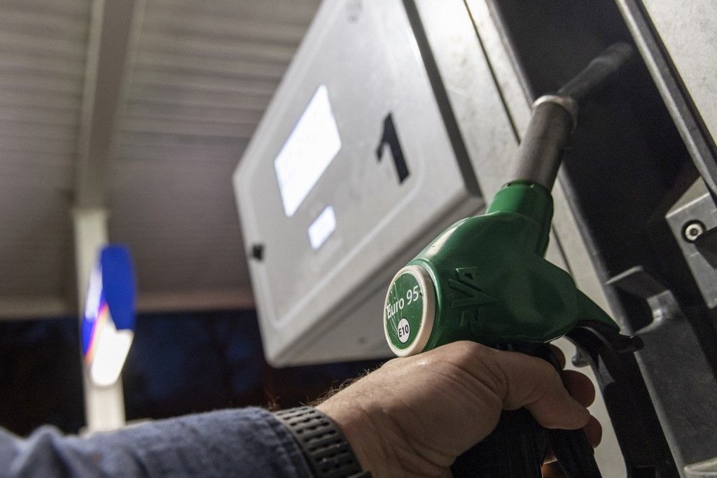 Closeup at the pump of Euro 95 E10 unleaded gasoline fuel. Gulf Oil gas station in Turnhout, Belgium on March 26, 2026. Fuel prices are seen on the board in euro currency during the night. Drivers face higher prices since the US/Israel - Iran war. Drivers from the neighboring country the Netherlands are driving to Belgium to fill up their cars with cheaper gasoline.  (Photo by Nicolas Economou/NurPhoto) (Photo by Nicolas Economou / NurPhoto via AFP)