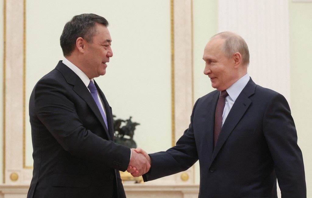 Russian President Vladimir Putin and Kyrgyzstan's President Sadyr Japarov shake hands during their meeting at the Kremlin in Moscow on April 23, 2026. (Photo by MAXIM SHIPENKOV / POOL / AFP)