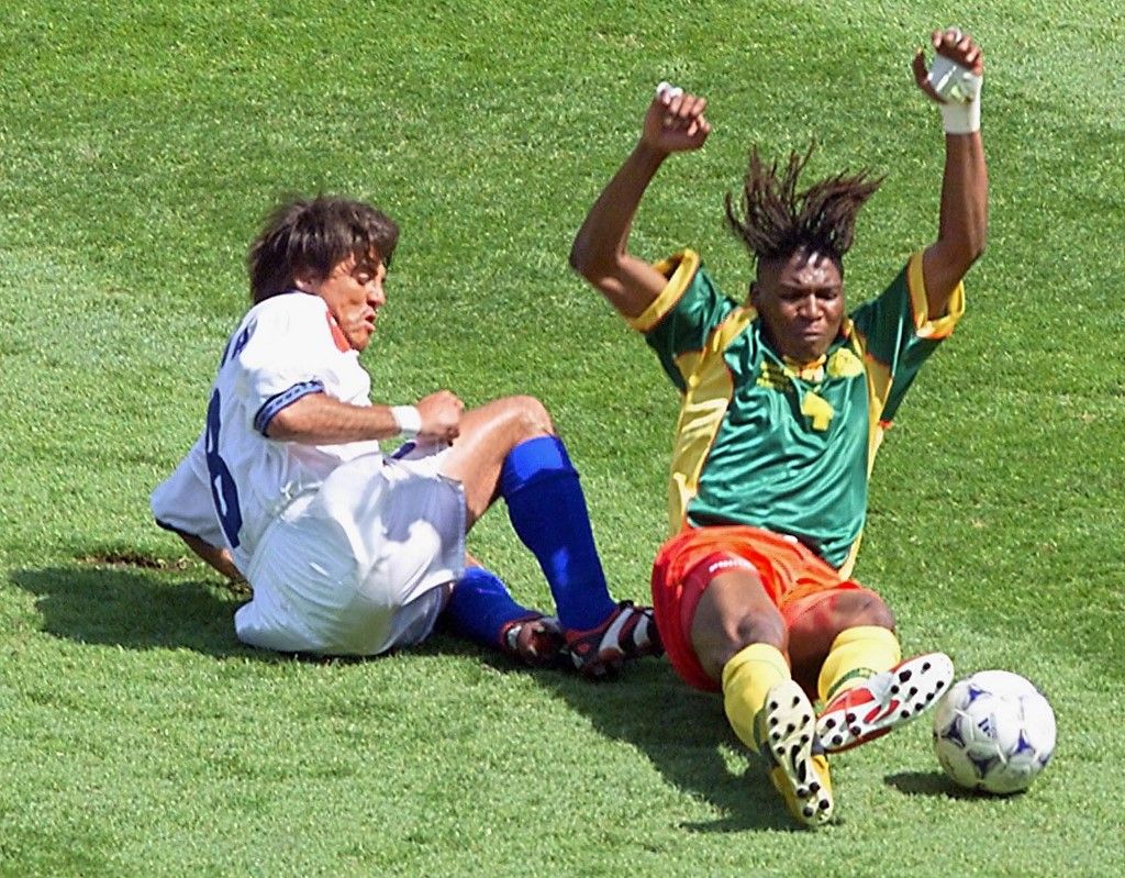 Chilean mid-fielder Clarence Acuna (L) and Cameroon's defender Rigobert Song (R) fall after tackling for the ball during the 1998 Soccer World Cup group B match between Chile and Cameroon, 23 June at the Stade de la Beaujoire in Nantes. Chile is leading 1-0. (ELECTRONIC IMAGE) AFP PHOTO (Photo by PASCAL GUYOT / AFP)