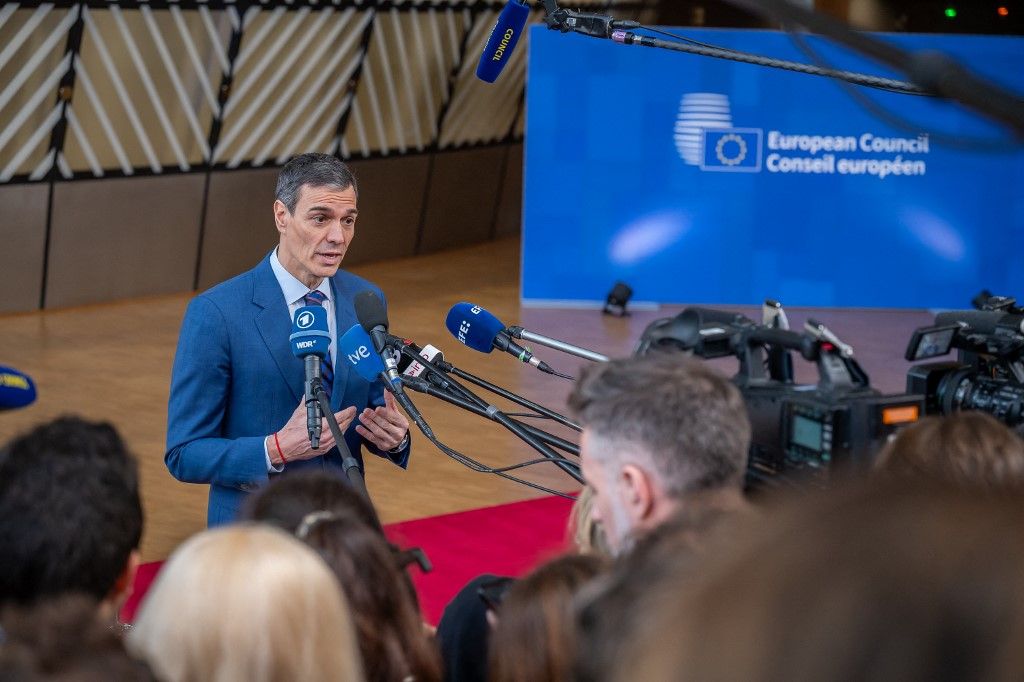 Prime Minister of Spain Pedro Sanchez Perez-Castejon speaks to journalists as he arrives prior to the European summit meeting in Brussels, Belgium, on March 19, 2026. The summit will address the military escalation in the Middle East and the situation in Iran, including its consequences on the European Union in terms of energy prices and energy security. (Photo by Jonathan Raa/NurPhoto) (Photo by Jonathan Raa / NurPhoto via AFP)