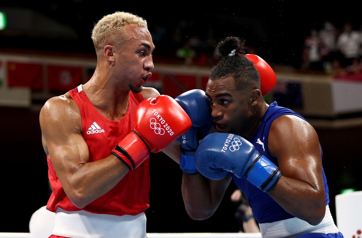 TOKYO, JAPAN - AUGUST 04: Benjamin Whittaker (red) of Team Great Britain exchanges punches with Arlen Lopez of Team Cuba during the Men's Light Heavy (75-81kg) final on day twelve of the Tokyo 2020 Olympic Games at Kokugikan Arena on August 04, 2021 in Tokyo, Japan. (Photo by Buda Mendes/Getty Images)