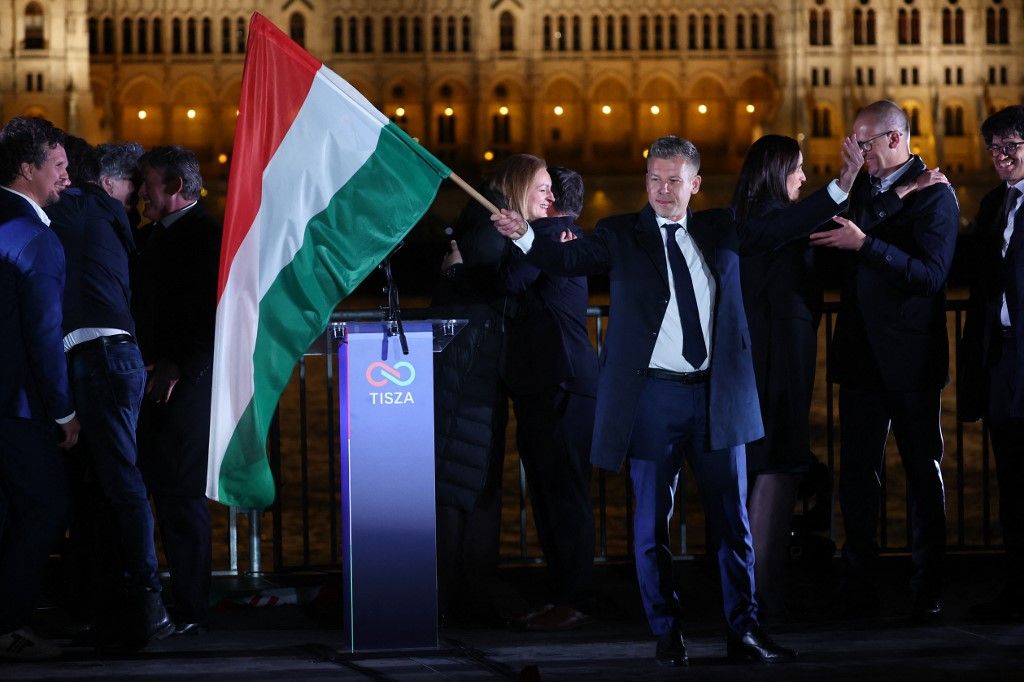 Tisza Party candidate for Hungarian Prime Minister Peter Magyar waves a flag during the election evening after he won parliamentary election in Budapest, Hungary on April 12, (Photo by Jakub Porzycki/NurPhoto) (Photo by Jakub Porzycki / NurPhoto via AFP)