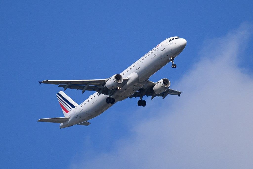 An Air France plane flies over Nantes, western France, on April 13, 2026. (Photo by Loic VENANCE / AFP)