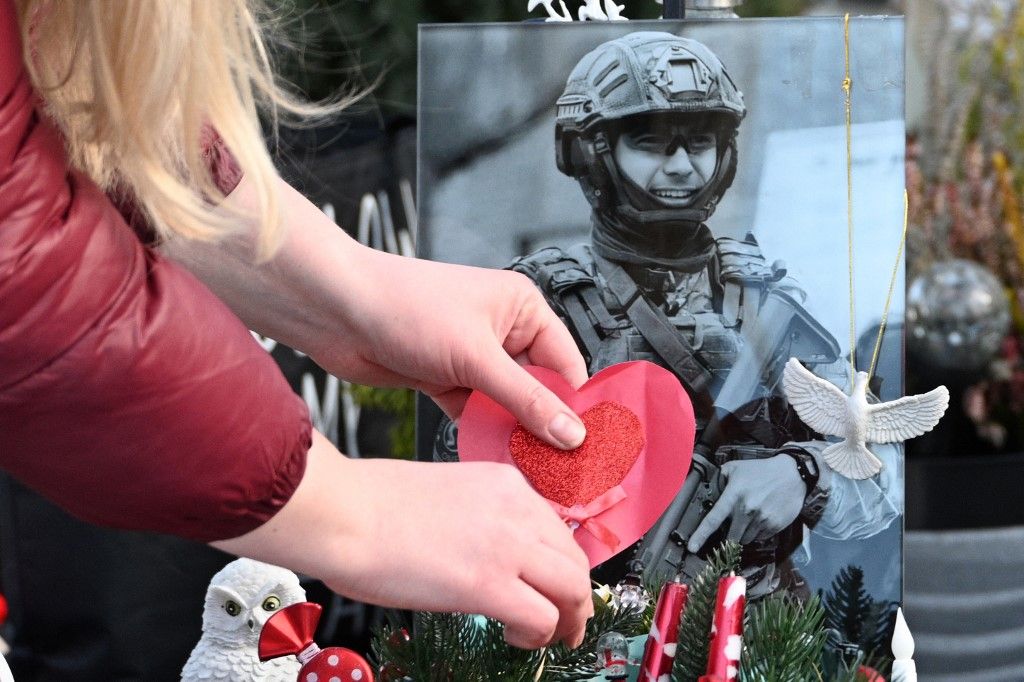 Eugena, widow of Ihor, a fallen Ukrainian soldier, visits his grave on Valentine's Day at the Lychakiv Military Cemetery in Lviv, on February 14, 2026, amid the Russian invasion of Ukraine. (Photo by YURIY DYACHYSHYN / AFP)