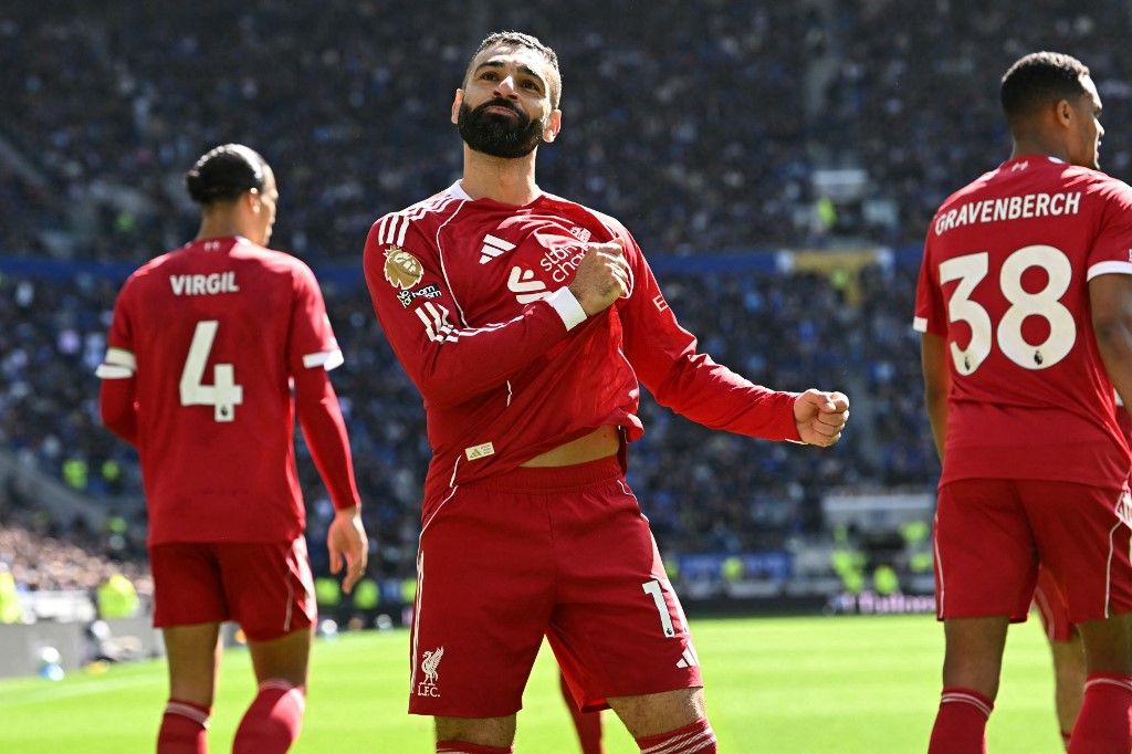 Liverpool's Egyptian striker #11 Mohamed Salah celebrates after scoring the opening goal of the English Premier League football match between Everton and Liverpool at Hill Dickinson Stadium in Liverpool, north west England on April 19, 2026. (Photo by Paul ELLIS / AFP) / RESTRICTED TO EDITORIAL USE. No use with unauthorized audio, video, data, fixture lists, club/league logos or 'live' services. Online in-match use limited to 120 images. An additional 40 images may be used in extra time. No video emulation. Social media in-match use limited to 120 images. An additional 40 images may be used in extra time. No use in betting publications, games or single club/league/player publications. / 