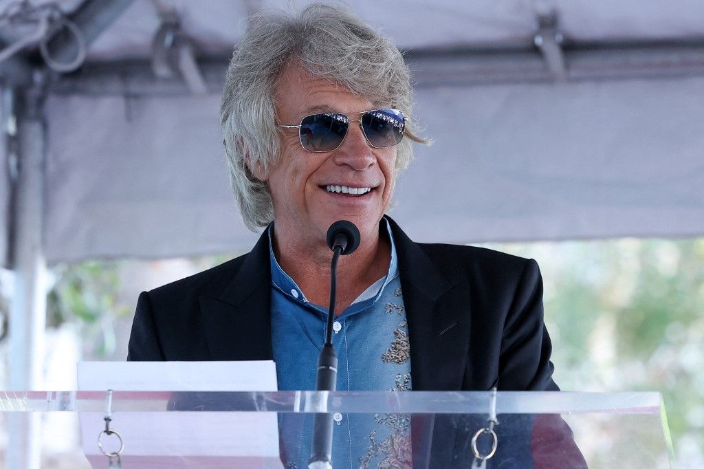 US musician Jon Bon Jovi speaks at English rock band Def Leppards Hollywood Walk of Fame star ceremony in front of Capitol Records Building in Los Angeles, California, on October 9, 2025. (Photo by VALERIE MACON / AFP)