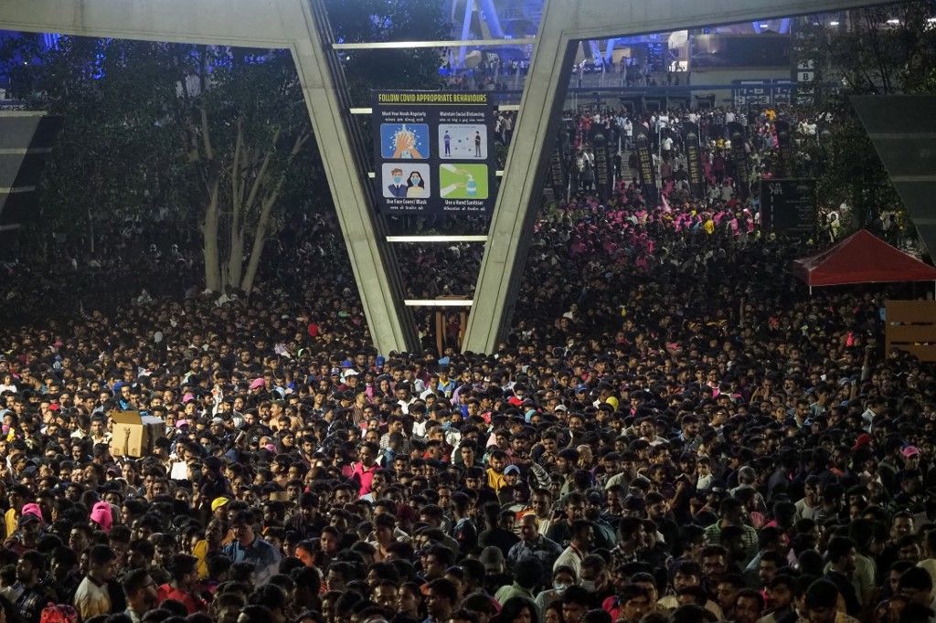 (FILES) In this file photo taken on April 16, 2023, spectators leave the Narendra Modi Stadium after watching the Indian Premier League (IPL) Twenty20 cricket match between Gujarat Titans and Rajasthan Royals in Ahmedabad. Every morning and evening -- and for several hours in between -- tens of millions of Indians sit idle on gridlocked highways and hang from the sides of packed passenger trains in what is becoming the world's most populous nation. (Photo by Sam PANTHAKY / AFP)