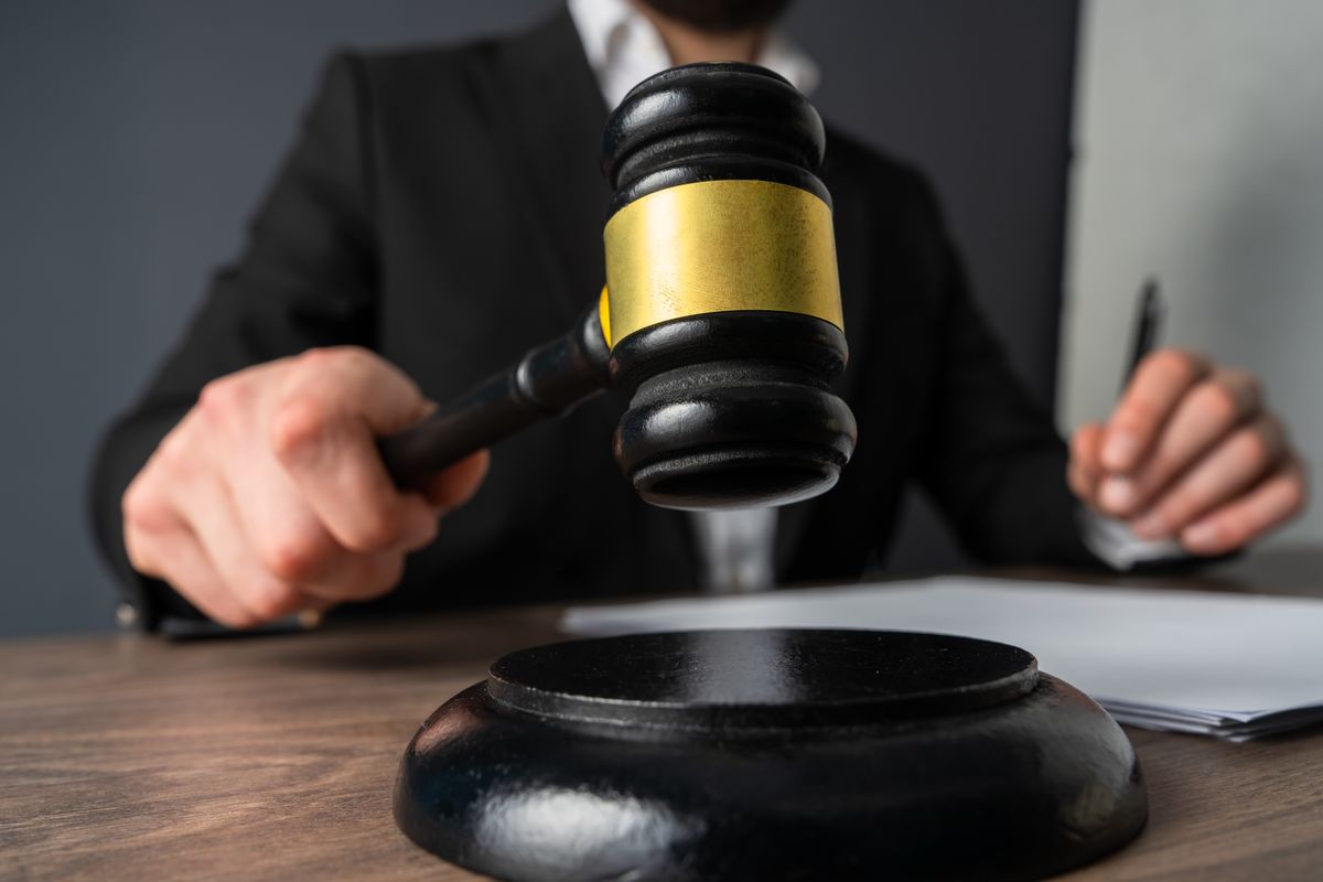 A judge’s gavel used in court to signal rulings, maintain order, and symbolize judicial authority and justice.