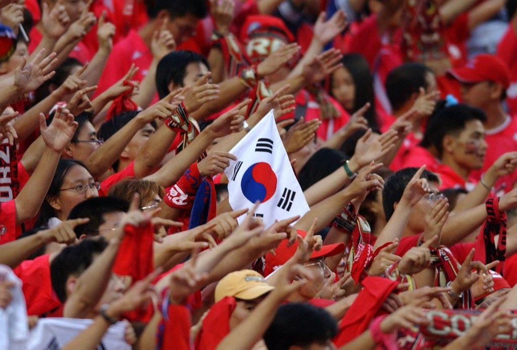 South Korean fans cheer their team on, 29 June 2002 at the Daegu World Cup Stadium in Daegu, during the third-place playoff between Korea and Turkey in the 2002 FIFA World Cup Korea/Japan. Turkey defeated South Korea 3-2 to claim third place. AFP PHOTO/EMMANUEL DUNAND (Photo by Emmanuel DUNAND / AFP)
