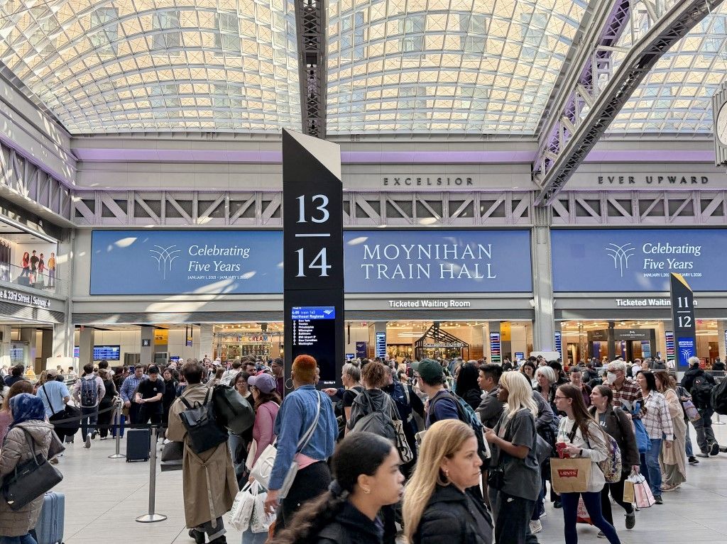 Commuters walk through Moynihan Train Hall in New York Penn station in New York on March 9, 2026. (Photo by Daniel SLIM / AFP)
