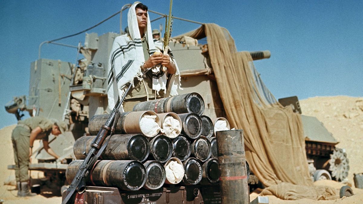 Lugas
An Israeli soldier, wearing a prayer shawl, holds the four plant species -- palm leave stalk, citrus, myrtle and willow-branches -- as he prays in October 1973 at a camp of the ISraeli army in the Sinaď desert, during the 1973 Arab-Israeli War. On October 6, 1973, on the Jewish holiday of Yom Kippur, an Arab military coalition led by Egypt and Syria launched a simultaneous surprise attack in the Sinai Peninsula and the Golan Heights, territories occupied by Israel since the 1967 Arab–Israeli War. This war provoked the oil shock of 1973 and led to the opening of peace negotiations between Israel and Egypt, concluded by the Camp David agreement in 1978. (Photo by AFP)