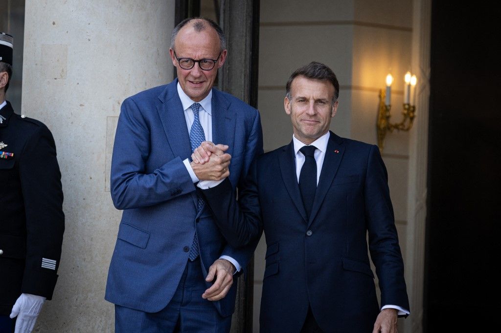France's President Emmanuel Macron welcomes Germany's Chancellor Friedrich Merz before a meeting on the Initiative for Maritime Navigation in the Strait of Hormuz at the Elysee Presidential Palace in Paris, France, on April 17, 2026. (Photo by Telmo Pinto/NurPhoto) (Photo by Telmo Pinto / NurPhoto via AFP)