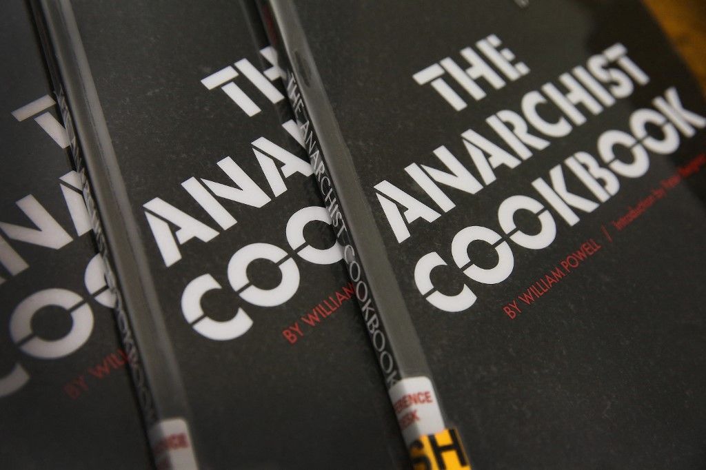 CHICAGO, IL - DECEMBER 17: Copies of The Anarchist Cookbook by William Powell are kept in the reference section of the Harold Washington Library on December 17, 2013 in Chicago, Illinois. William Powell, who published the book in 1971 at the age of 19, has requested the book be taken 'quietly and immediately out of print', after discovering that the book was studied by the student who recently opened fire at Arapahoe High School in Colorado, Powell. (Photo Illustration by Scott Olson/Getty Images/AFP (Photo by SCOTT OLSON / GETTY IMAGES NORTH AMERICA / Getty Images via AFP)