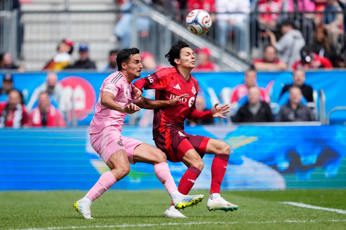 TORONTO, ONTARIO - MAY 09: Daniel Salloi #20 of Toronto FC and Gonzalo Luján #2 of Inter Miami CF compete for the ball during the MLS match between Toronto FC and Inter Miami CF at BMO Field on May 09, 2026 in Toronto, Ontario.   Mark Blinch/Getty Images/AFP (Photo by MARK BLINCH / GETTY IMAGES NORTH AMERICA / Getty Images via AFP)